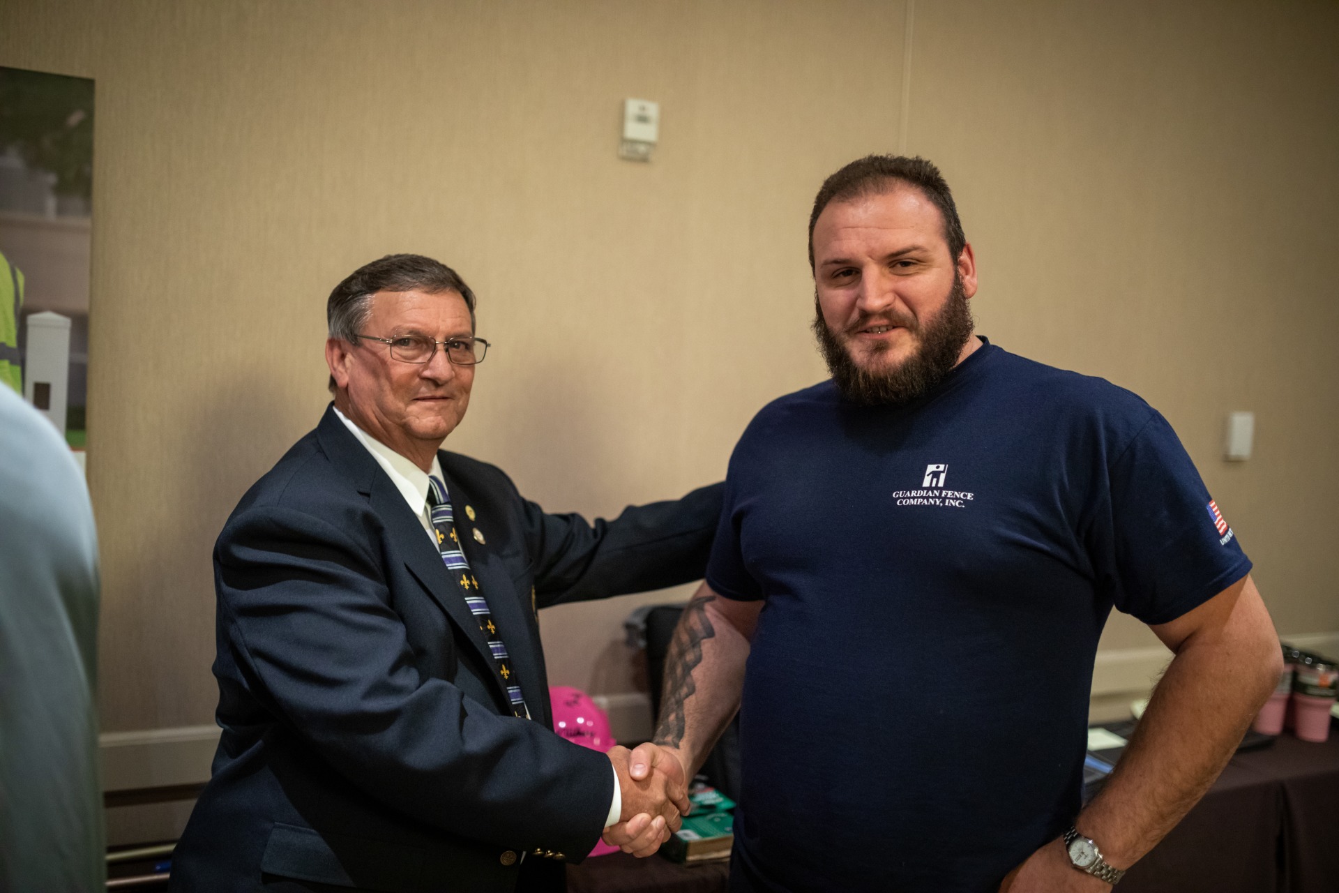 An AFA Training graduate shaking hands with an instructor.