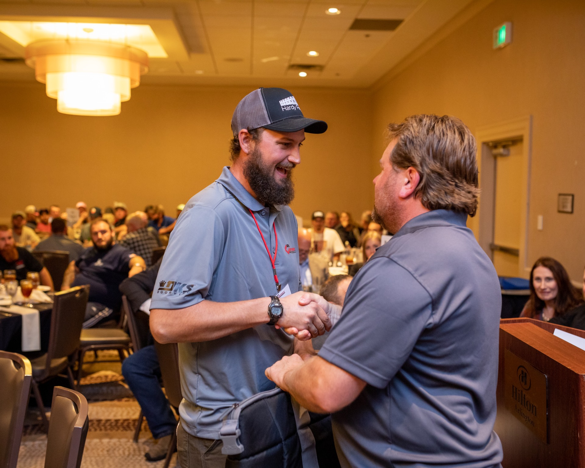 An AFA Training graduate shaking hands with an instructor.