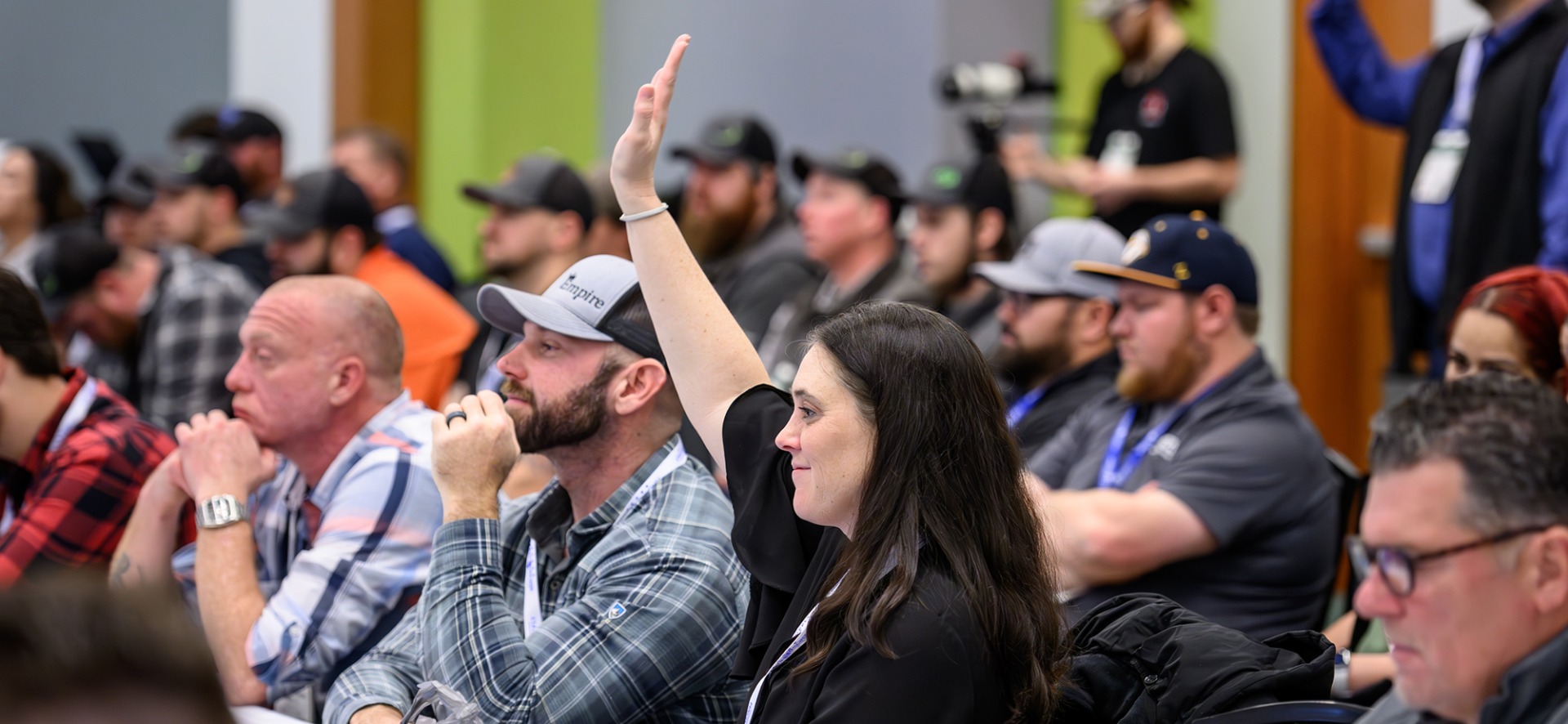 American Fence Association Fence Contractor Business School student raising their hand in class.